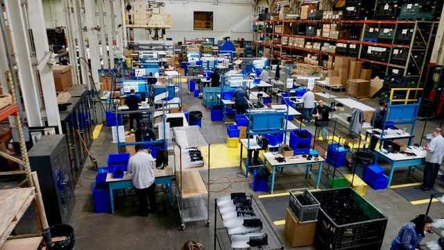 Workers assembling parts created through additive manufacturing services by RCO
